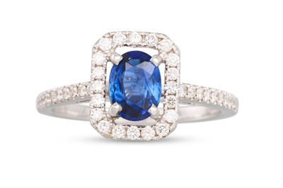 Lot 210 - A SAPPHIRE AND DIAMOND CLUSTER RING, the oval...