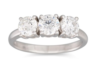 Lot 211 - A DIAMOND THREE STONE RING, the brilliant cut...