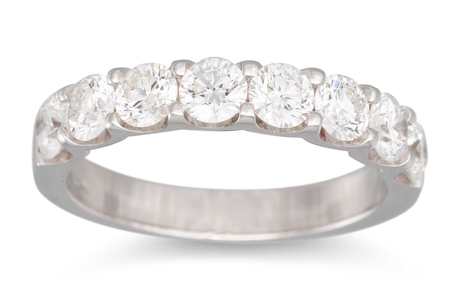 Lot 212 - A SEVEN STONE DIAMOND RING, the brilliant cut...