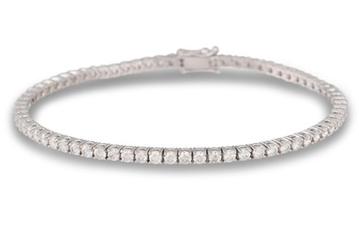 Lot 217 - A DIAMOND LINE BRACELET, the brilliant cut...