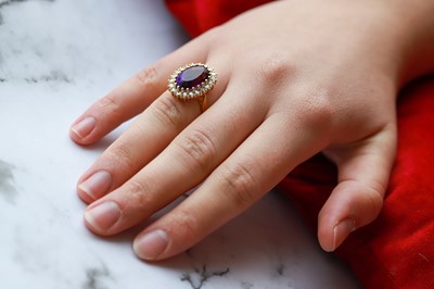 Lot 121 - AN AMETHYST AND DIAMOND CLUSTER RING, the oval...