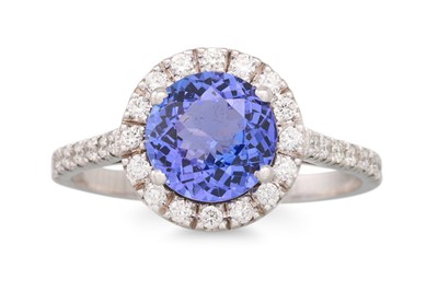 Lot 245 - A TANZANITE AND DIAMOND RING, the circualar...