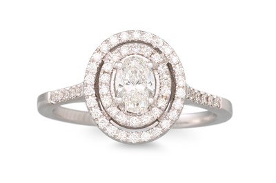 Lot 246 - A DIAMOND 'HALO' CLUSTER RING, of oval form,...