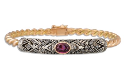 Lot 257 - A DIAMOND AND RUBY BANGLE, the oval ruby to...