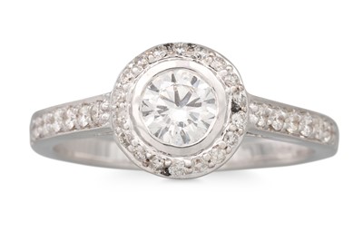 Lot 106 - A DIAMOND HALO CLUSTER RING, set with...
