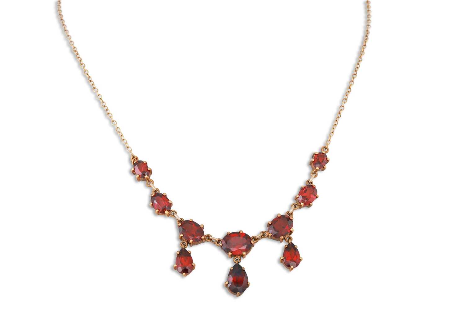 Lot 20 - AN ANTIQUE GARNET NECKLACE, the pear, and oval...
