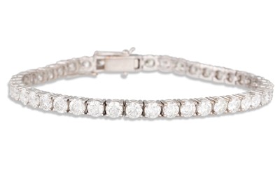 Lot 334 - A DIAMOND LINE BRACELET, the brilliant cut...