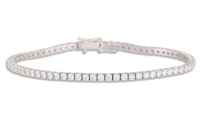 Lot 336 - A DIAMOND LINE BRACELET, the brilliant cut...