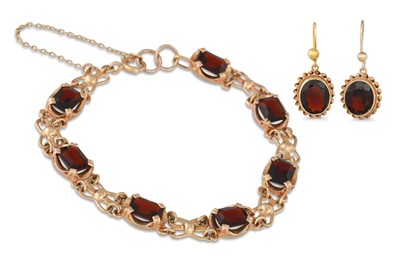 Lot 54 - A GARNET BRACELET, in 9ct gold with matching...