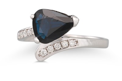 Lot 253 - A SAPPHIRE AND DIAMOND RING, the pear shaped...