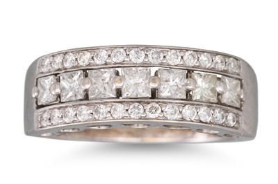 Lot 365 - A DIAMOND TRIPLE ROWED RING, the row of...