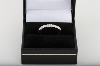 Lot 217 - A DIAMOND SET HALF HOOP ETERNITY RING, mounted...