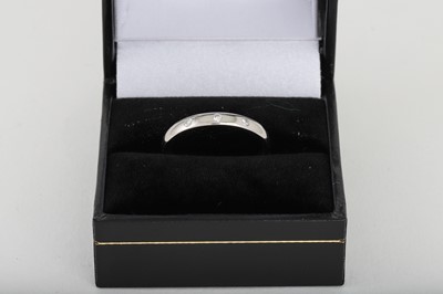 Lot 173 - A PLATINUM DIAMOND SET BAND, size M - N