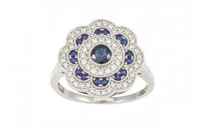 Lot 177 - A DIAMOND AND SAPPHIRE CLUSTER RING, shaped...