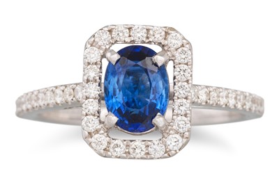 Lot 217 - A SAPPHIRE AND DIAMOND CLUSTER RING, the oval...