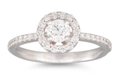 Lot 222 - A DIAMOND HALO CLUSTER RING, set with...