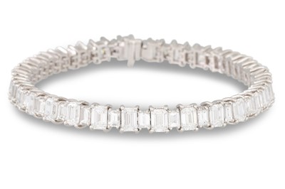 Lot 242 - A DIAMOND LINE BRACELET, the emerald cut...