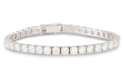 Lot 243 - A DIAMOND LINE BRACELET, the brilliant cut...