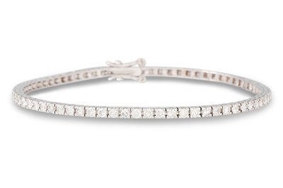 Lot 244 - A DIAMOND LINE BRACELET, the brilliant cut...