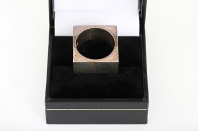 Lot 138 - A RUDOLF HELZEL SILVER RING, of square form,...