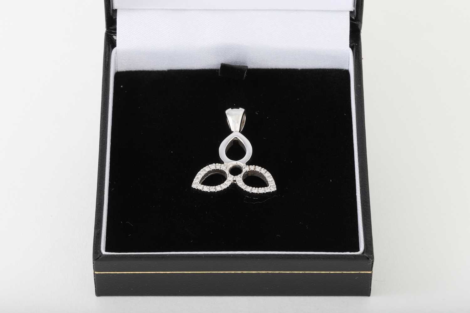 Lot 92 - A DIAMOND PENDANT, shaped form, mounted in...