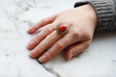 Lot 132 - A CORAL AND DIAMOND CLUSTER RING, the cabochon...