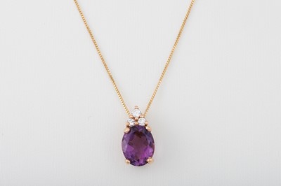 Lot 55 - AN AMETHYST AND DIAMOND PENDANT, the oval...