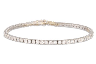 Lot 238 - A DIAMOND LINE BRACELET, the brilliant cut...