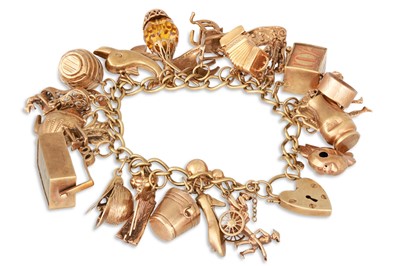 Lot 109 - A GOLD CHARM BRACELET, set with various charms,...