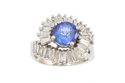Lot 385 - A TANZANITE AND DIAMOND CLUSTER RING, the...