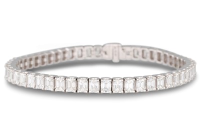 Lot 258 - A DIAMOND LINE BRACELET, the emerald cut...