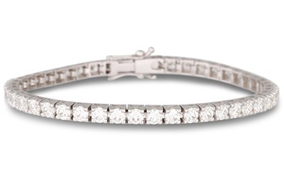 Lot 259 - A DIAMOND LINE BRACELET, the brilliant cut...