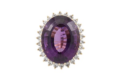 Lot 404 - AN AMETHYST AND DIAMOND RING, the large oval...