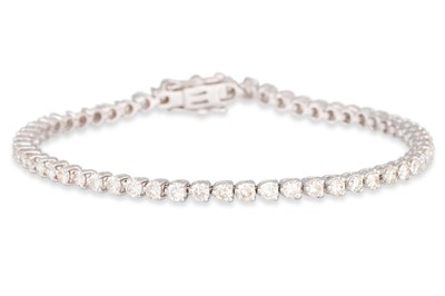 Lot 222 - A DIAMOND LINE BRACELET, the brilliant cut...