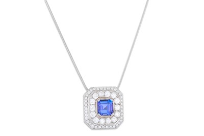 Lot 225 - A TANZANITE AND DIAMOND CLUSTER PENDANT, the...