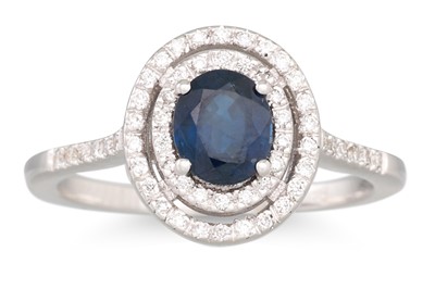 Lot 245 - A SAPPHIRE AND DIAMOND CLUSTER RING, the oval...