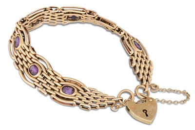 Lot 134 - A AMETHYST SET GATE BRACELET, mounted in 9ct...