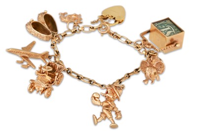 Lot 2 - A 9CT GOLD CHARM BRACELET, with various charms...