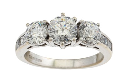 Lot 397 - A THREE STONE DRESS RING, mounted in 9ct white...