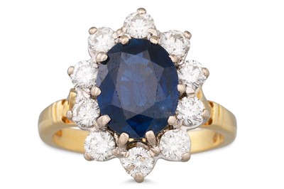 Lot 101 - A SAPPHIRE AND DIAMOND CLUSTER RING, the oval...