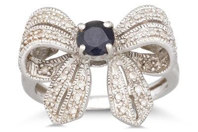 Lot 27 - A DIAMOND AND GEM SET RING, modelled as a bow,...