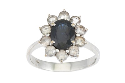 Lot 409 - A SAPPHIRE AND WHITE GEM STONE CLUSTER RING,...