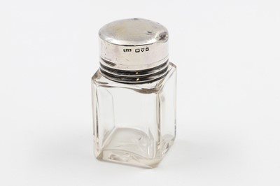 Lot 199 - AN EDWARDIAN SILVER MOUNTED PERFUME BOTTLE, by...