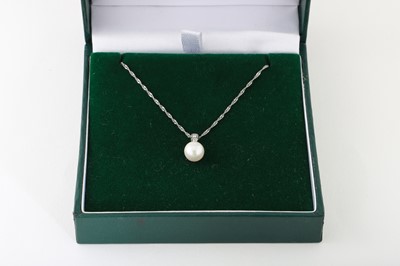 Lot 283 - A 10CT GOLD PEARL AND DIAMOND PENDANT, with a...