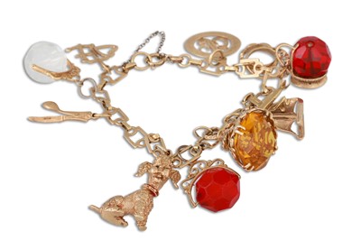 Lot 185 - A 9CT YELLOW GOLD CHARM BRACELET, set with...