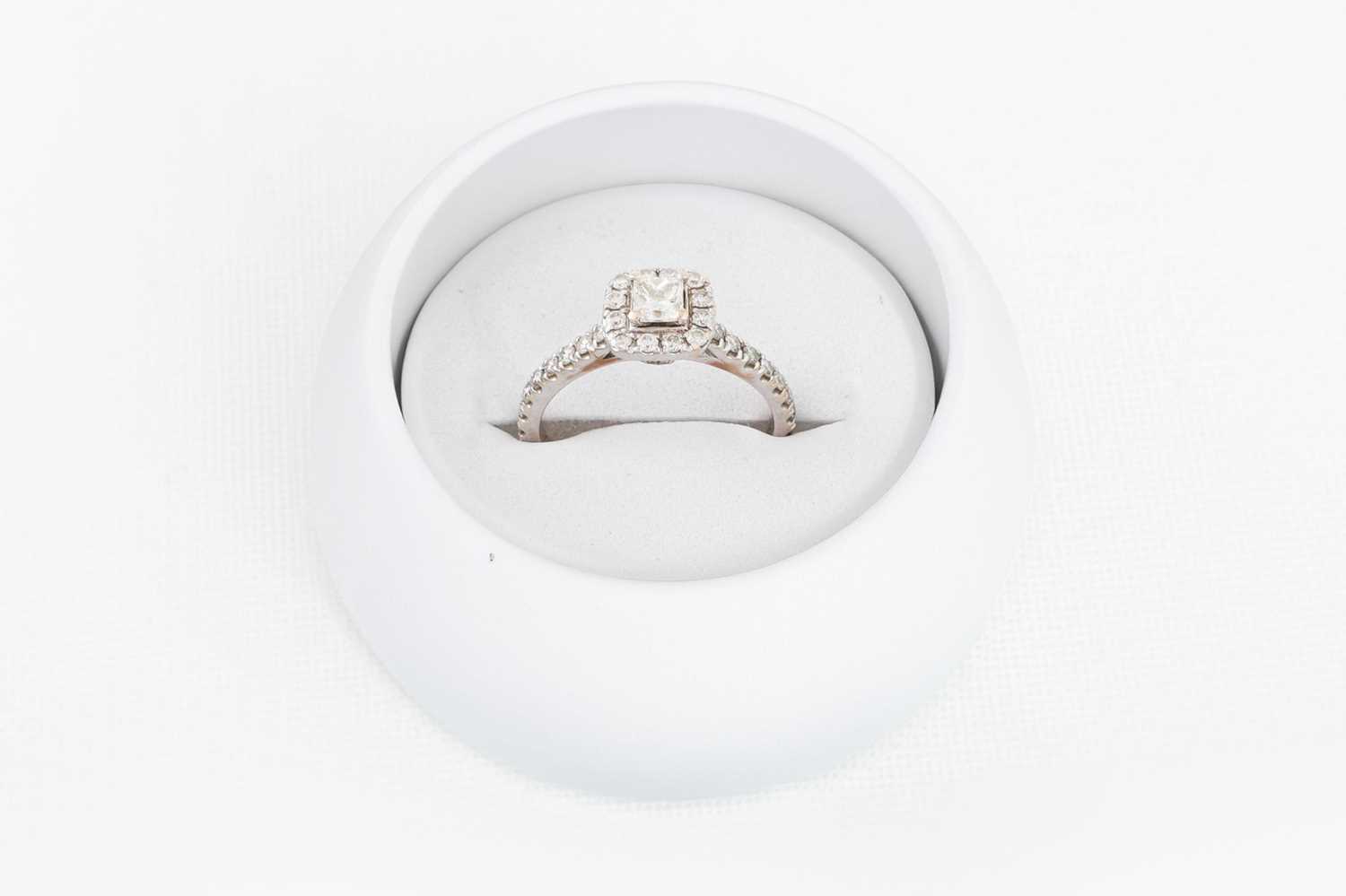 Lot 11 - A DIAMOND CLUSTER RING, the princess cut...