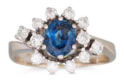 Lot 303 - A SAPPHIRE AND DIAMOND CLUSTER RING, the oval...