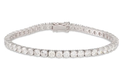 Lot 324 - A DIAMOND LINE BRACELET, the brilliant cut...