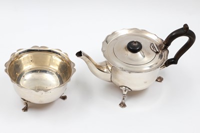 Lot 252 - A MODERN SILVER TEA POT, with wavy border and...