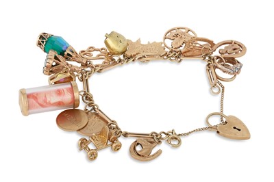 Lot 227 - A VINTAGE 9CT GOLD CHARM BRACELET, various...